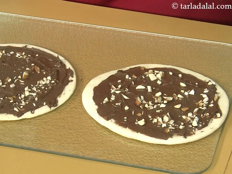 Step 26 – Sprinkle 1 tbsp of almonds over each pizza base.