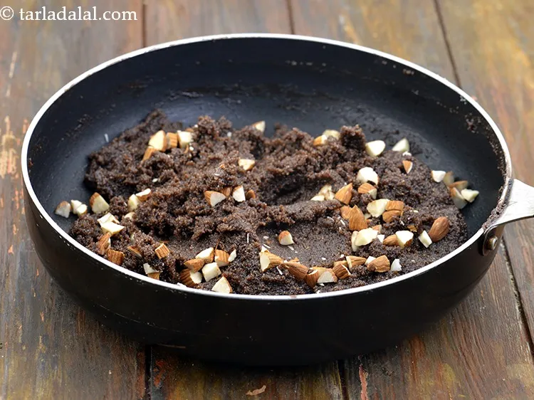 Step 24 – Switch off the flame, add 2 tbsp&nbsp;<a href="https://www.tarladalal.com/glossary-chopped-almonds-865i">chopped almonds (badam)</a>&nbsp;and mix well.