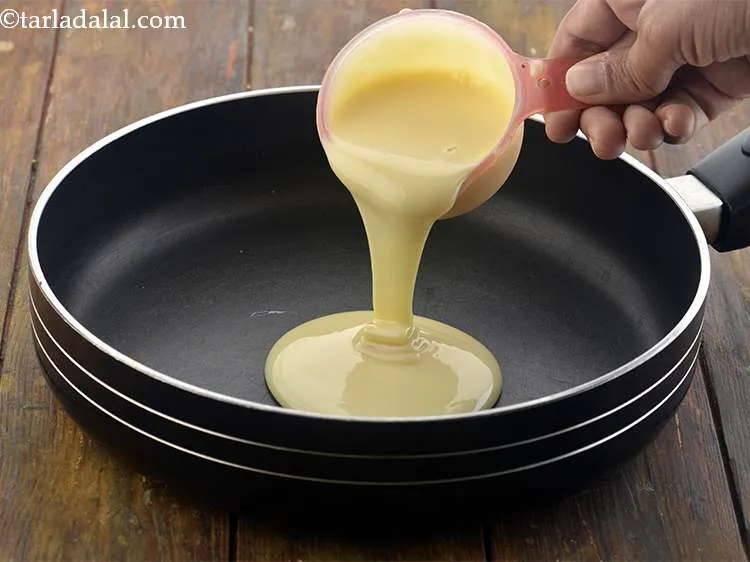 Step 16 – Take a broad non- stick pan and add the condensed milk. Make sure that your …