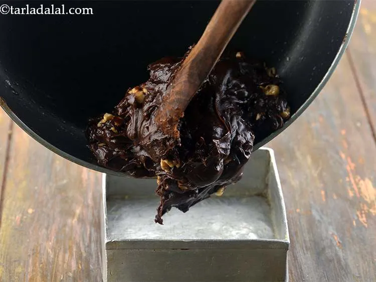 Step 10 – Transfer the mixture immediately (while it is hot) into the greased tin and spread it …