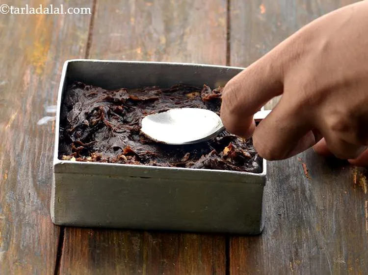 Step 19 – Transfer the mixture immediately (while it is hot) into the greased tin and spread it …