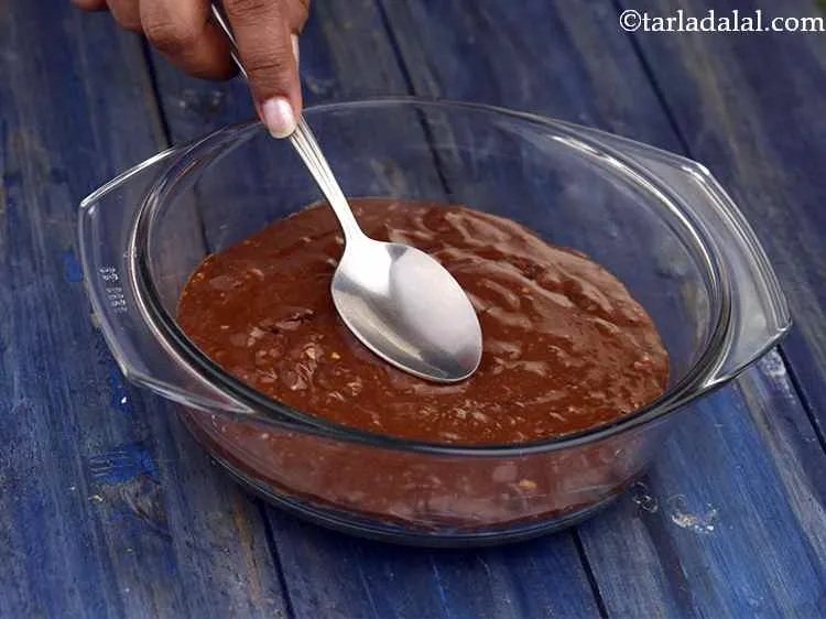 Step 9 – Pour the batter into the greased and lined microwave safe dish, spread it evenly using …