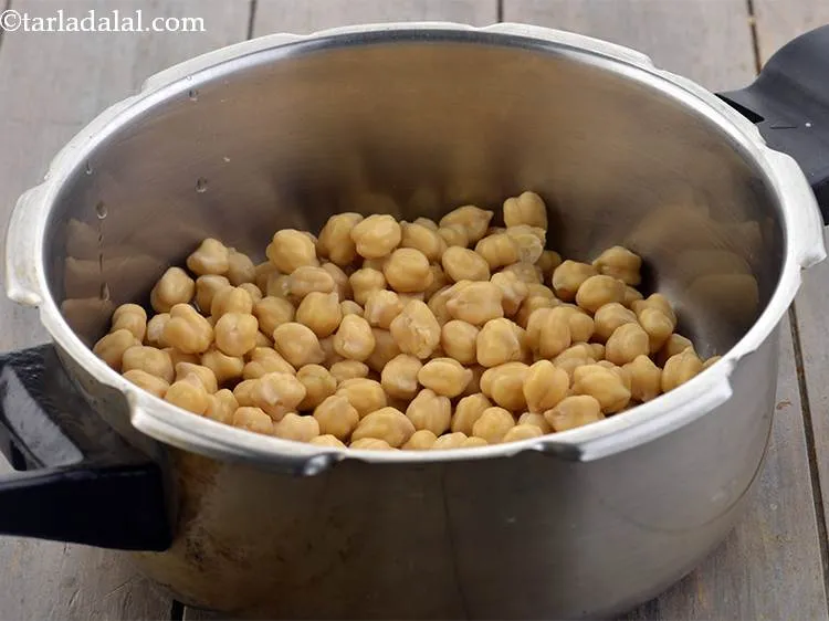 Step 7 – In a pressure cooker, add the kabuli chana.
