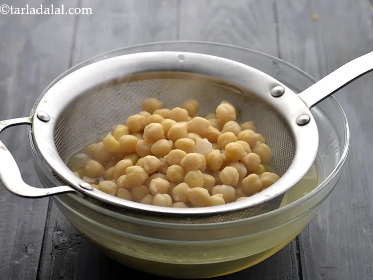 Step 10 – Drain the boiled kabuli chana using a strainer and keep aside. You can reserve the …