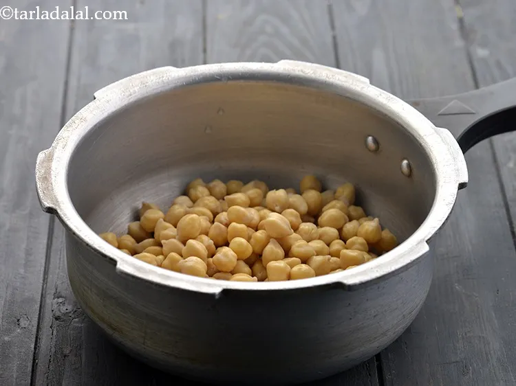 Step 7 – Transfer the soaked chana to a pressure cooker.