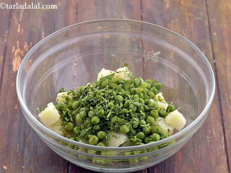 Step 29 – Add the coriander as well. Fresh coriander gives freshness to the tikkis.
