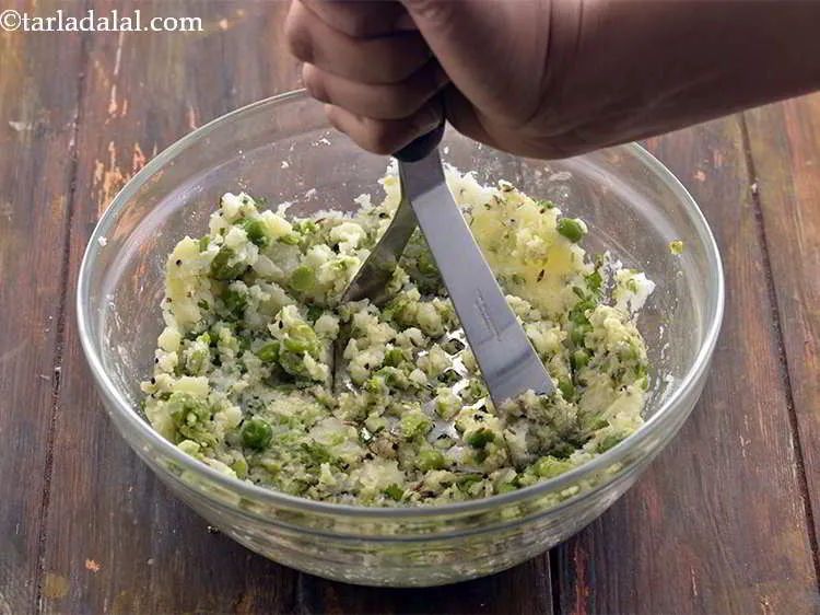 Step 33 – Mash the mixture with a potato masher till coarse.