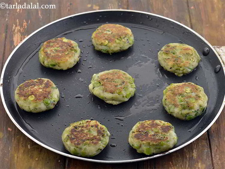 Step 41 – Turn the tikkis over and cook till they turn golden brown in colour from both …