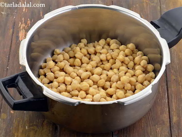 Step 4 – Put the soaked chickpeas in the pressure cooker. Alternately, you can even boil them but …