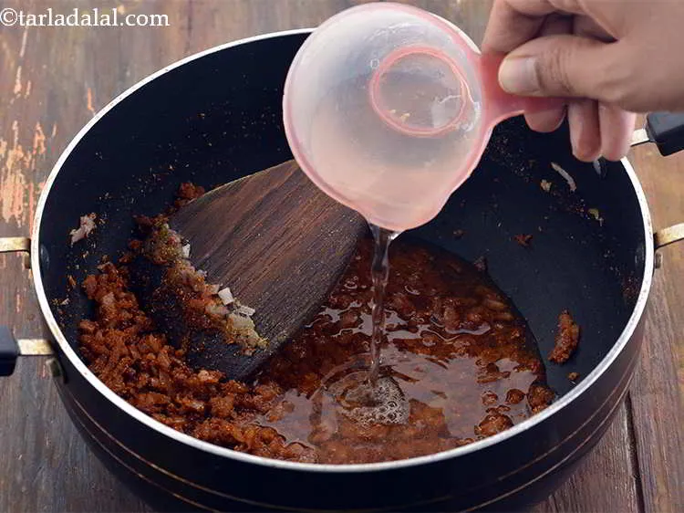 Step 15 – Now add &frac12; cup of water to the masalas. This will give some gravy to …