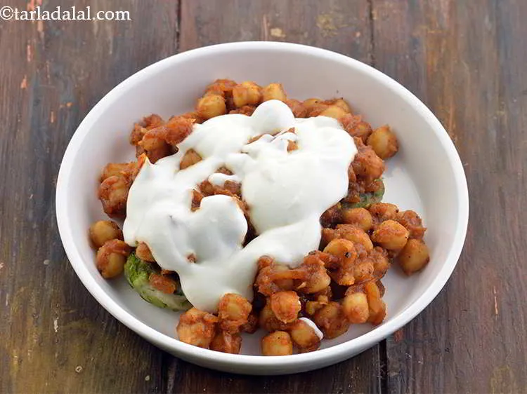 Step 44 – Spread 2 tbsp curds over the chole. This will give a certain coolness to the …