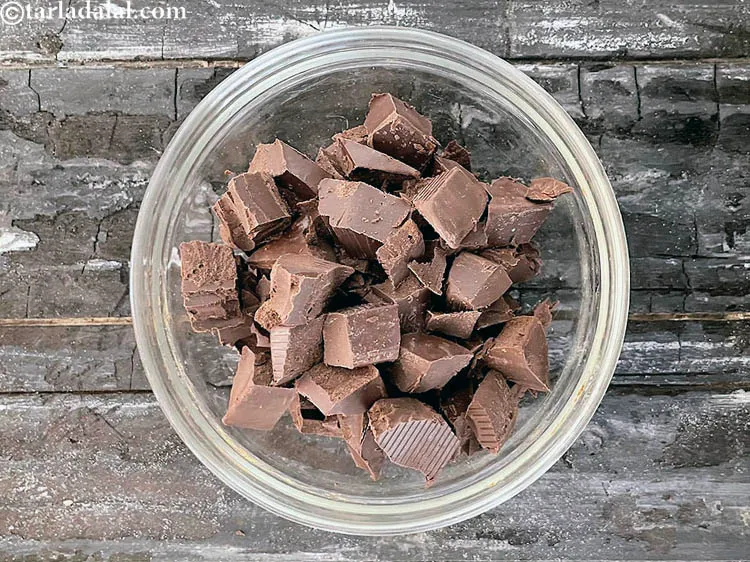Step 13 – Switch off the flame, add 1/4 cup&nbsp;<a href="https://www.tarladalal.com/glossary-chopped-dark-chocolate-792i">chopped dark chocolate</a>.