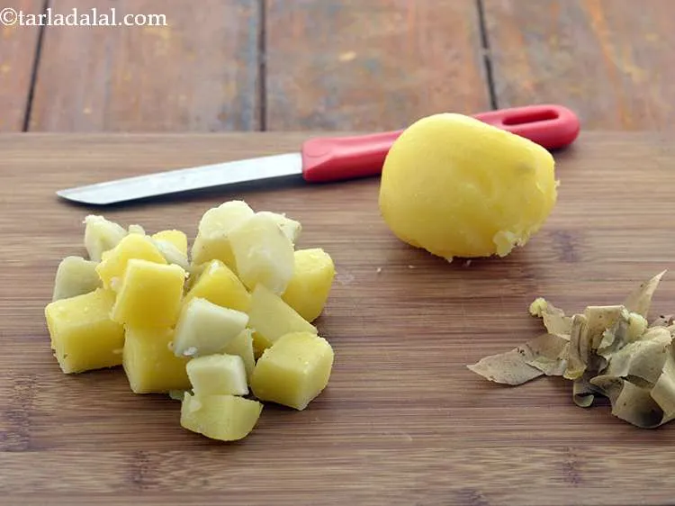 Step 11 – Add 1/2 cup&nbsp;roughly chopped&nbsp;<a href="https://www.tarladalal.com/glossary-boiled-potato-1667i">boiled potatoes</a>.