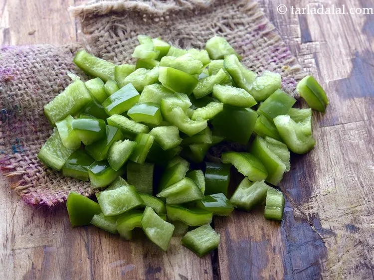 Step 7 – Add 3/4 cup&nbsp;<a href="https://www.tarladalal.com/glossary-capsicum-cubes-170i">capsicum cubes</a>.