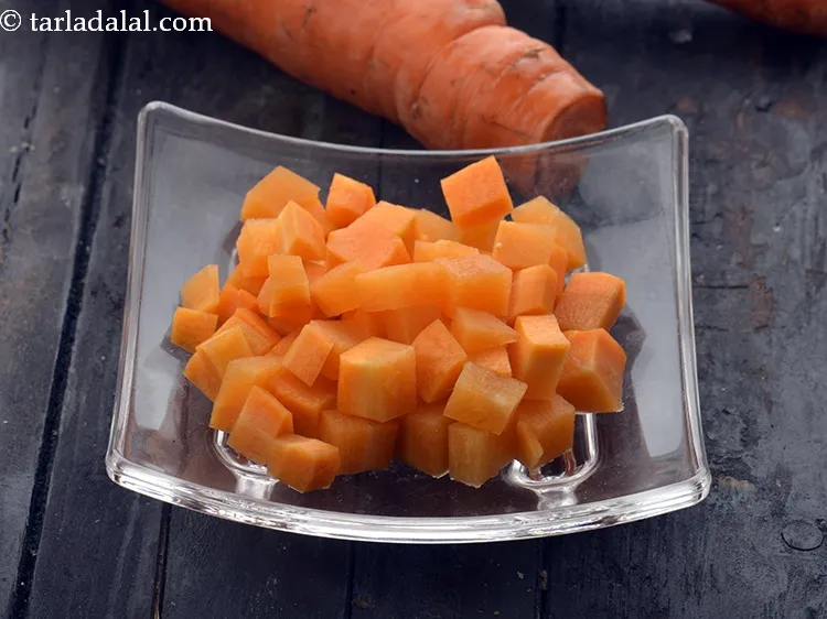 Step 15 – Add 1/4 cup&nbsp;<a href="https://www.tarladalal.com/glossary-chopped-carrot-798i">chopped carrot</a>.
