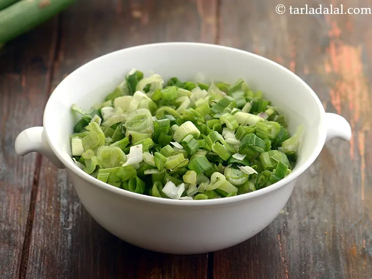 Step 34 – Add 1/2 cup&nbsp;finely&nbsp;<a href="https://www.tarladalal.com/glossary-chopped-spring-onion-whites-815i">chopped spring onion whites</a>&nbsp;and&nbsp;<a href="https://www.tarladalal.com/glossary-chopped-spring-onion-greens-1030i">greens</a>.