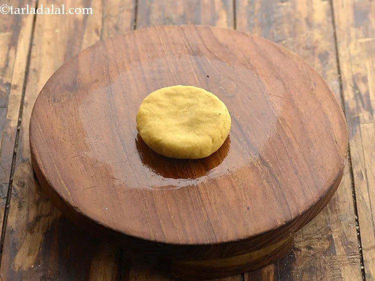 Step 21 – Place the flattened portion on the greased rolling board.&nbsp;