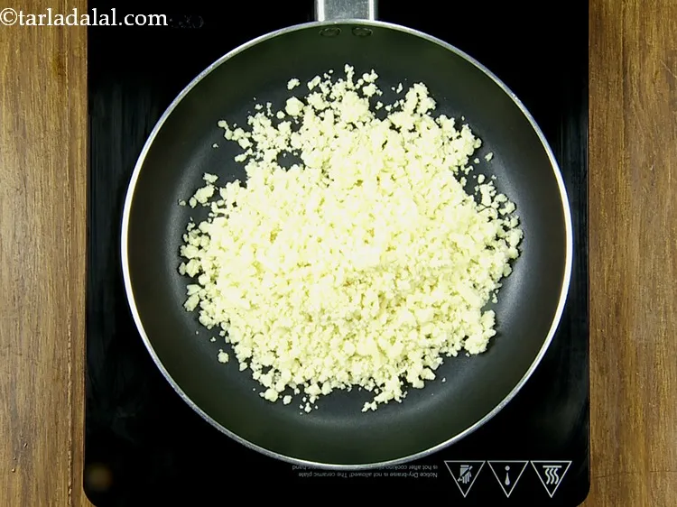Step 47 – In a broad non-stick pan, add 1/2 cup&nbsp;<a href="https://www.tarladalal.com/glossary-crumbled-mawa-2259i">crumbled mawa (khoya)</a>.