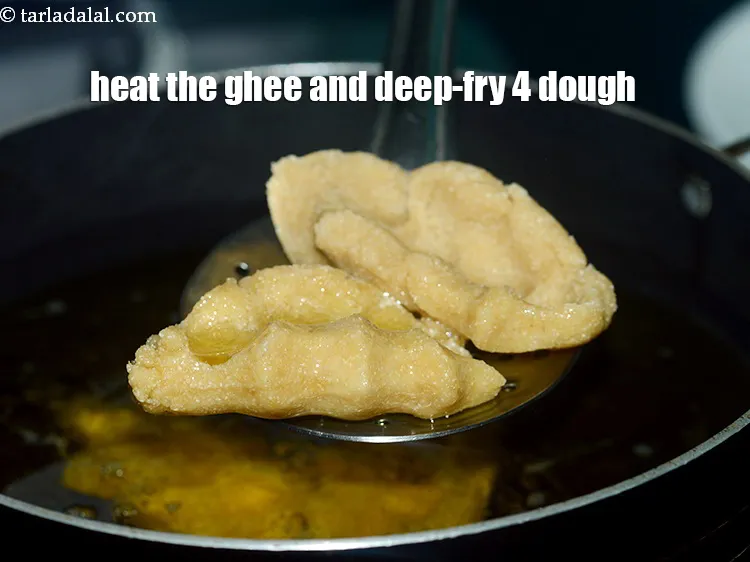 Step 39 – To get a beautiful flavour of&nbsp;atta churma ladoo, we are making use of ghee for …