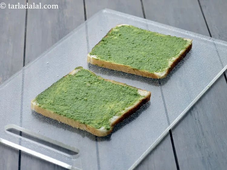Step 13 – Spread 1 tsp of <a href="https://www.tarladalal.com/green-chutney-22266r">green chutney</a> on each buttered bread slice.