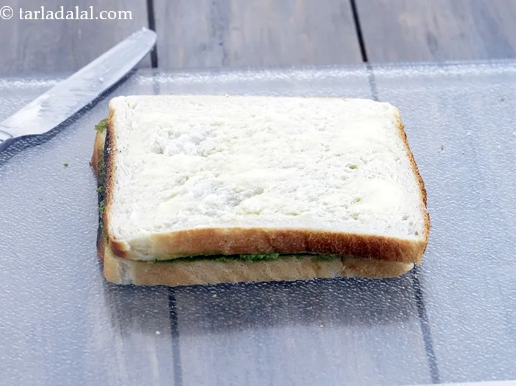 Step 16 – Spread &frac14; tsp of <a href="https://www.tarladalal.com/glossary-butter-makhan-233i">butter</a>&nbsp;evenly over it.