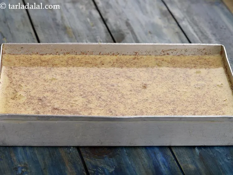 Step 14 – Pour the mixture of <strong>cinnamon spiced peach ice cream</strong> into a shallow aluminium container.&nbsp;