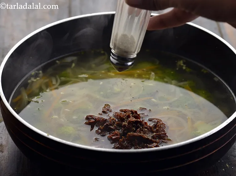 Step 14 – Add pepper, mix&nbsp;&nbsp;<strong>Clear broccoli carrot soup&nbsp;</strong>well and cook on a medium flame for 1 minute, …