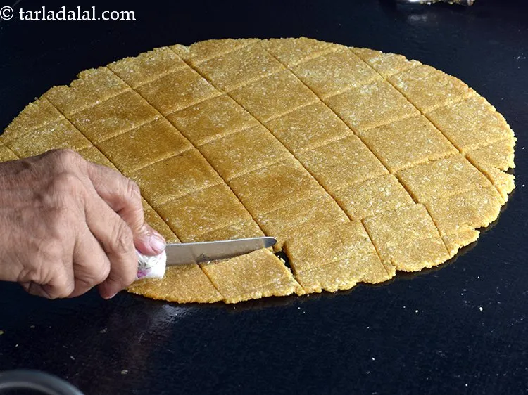 Step 13 – Cut immediately using a sharp knife into equal square pieces. Make the cut marks of …