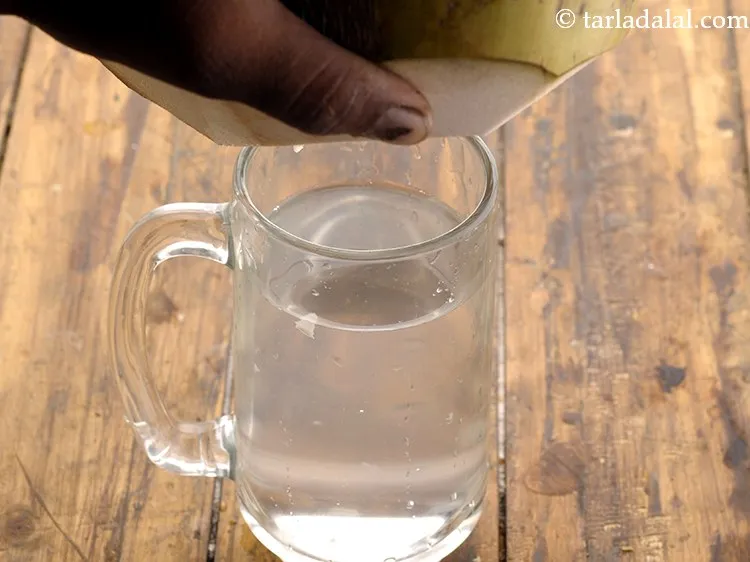 Step 17 – Invert the tender coconut over a glass and collect the&nbsp;<strong>coconut drink</strong>. This is coconut water …
