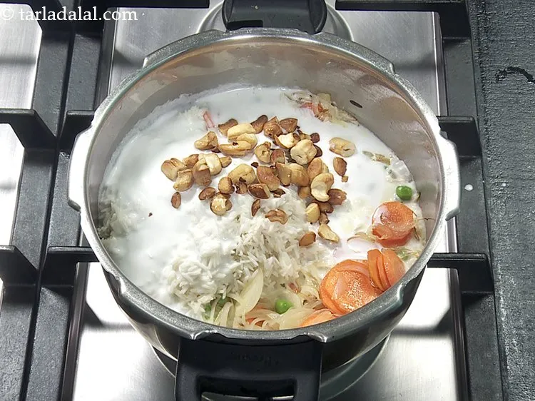 Step 33 – Add 2 tbsp&nbsp;<a href="https://www.tarladalal.com/glossary-fried-cashew-nut-908i">fried cashewnuts (kaju)</a>.