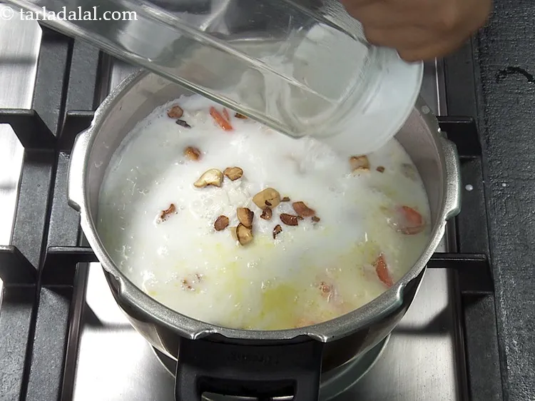 Step 34 – Add 1&frac12; cups of hot water. Use of hot water helps in cooking the <strong>coconut …