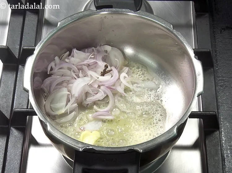 Step 24 – Add 2&nbsp;<a href="https://www.tarladalal.com/glossary-cloves-322i">cloves (laung / lavang)</a>.