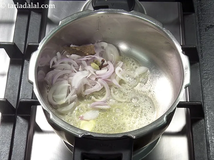 Step 26 – Add 2&nbsp;<a href="https://www.tarladalal.com/glossary-cardamom-elaichi-262i">cardamoms</a>.