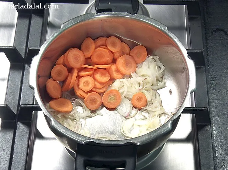 Step 28 – Add 1/2 cup&nbsp;<a href="https://www.tarladalal.com/glossary-carrot-roundels-2352i">carrot roundels</a>.