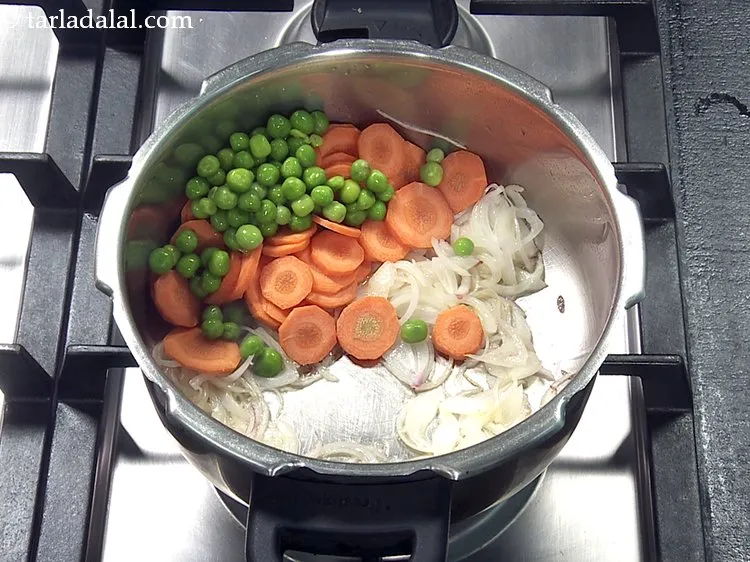 Step 29 – Add 1/4 cup&nbsp;<a href="https://www.tarladalal.com/glossary-green-peas-matar-hare-matar-vatana-180i">green peas</a>.
