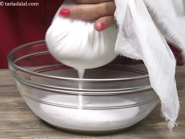Step 7 – Strain the blended&nbsp;<strong>coconut milk</strong>&nbsp;through the damp muslin cloth.
