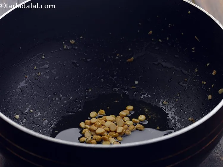 Step 19 – For making the thengai sadam, heat the oil in the same non-stick deep kadhai, add …