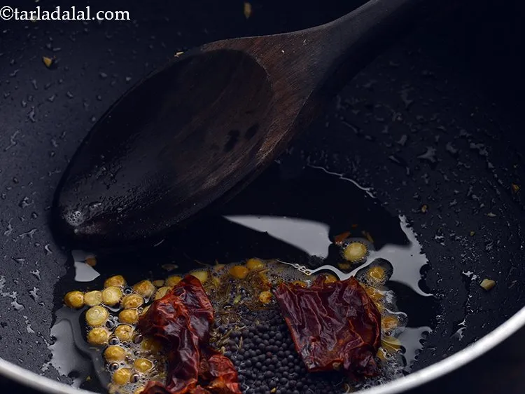 Step 22 – Add the red chillies. Remove the stem and break them into pieces before adding.