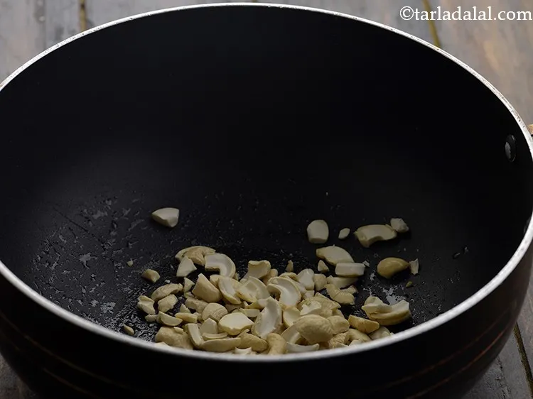 Step 16 – Add the cashew nuts. Ghee enhances the flavour of toasted kaju.