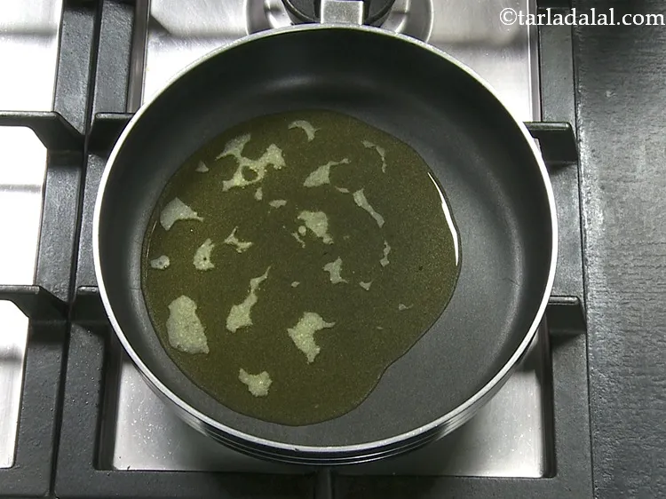 Step 2 – <p>For making the <strong>coconut sheera</strong>, heat the ghee in a broad non-stick pan.</p>