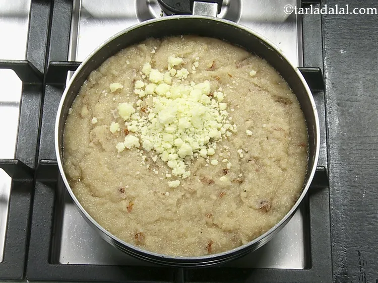 Step 14 – <p>Add mawa. This gives a rich and creamy mouthfeel to the <strong>coconut sheera</strong>. Learn how …