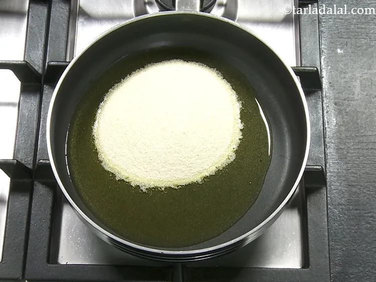 Step 3 – <p>Once the ghee is moderately hot, add the semolina.</p>