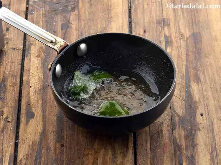 Step 12 – When the urad dal turns light brown in colour, add the remaining 4 curry leaves.
