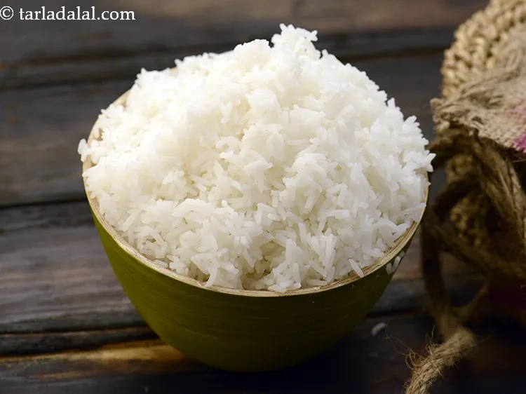 Step 22 – Once the raw mangoes are cooked,&nbsp;add 2 1/2 cups&nbsp;<a href="https://www.tarladalal.com/cooked-rice-32639r">cooked rice</a>.&nbsp;