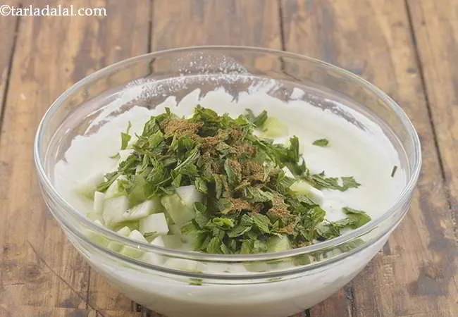 Step 5 – Add the cumin seeds powder to the&nbsp;<strong>Cucumber and Pudina Raita ( Mint Cucumber Raita)</strong>.