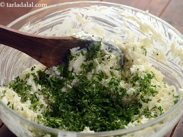 Step 18 – Add coriander. For a crunchy mouthfeel, you can garnish <strong>coriander curd rice</strong> with roasted cashews …