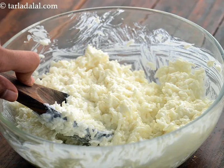 Step 11 – Mix well and mash the curd rice with the back of a spoon or using …