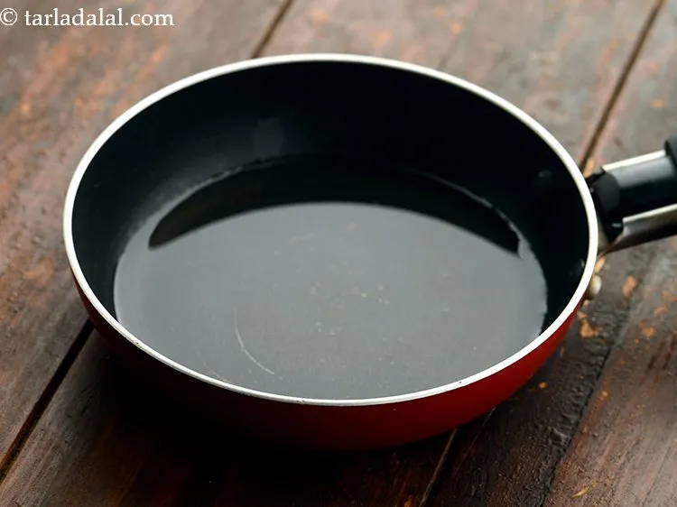 Step 12 – For tempering the South-Indian curd rice, heat the ghee in a small katori.