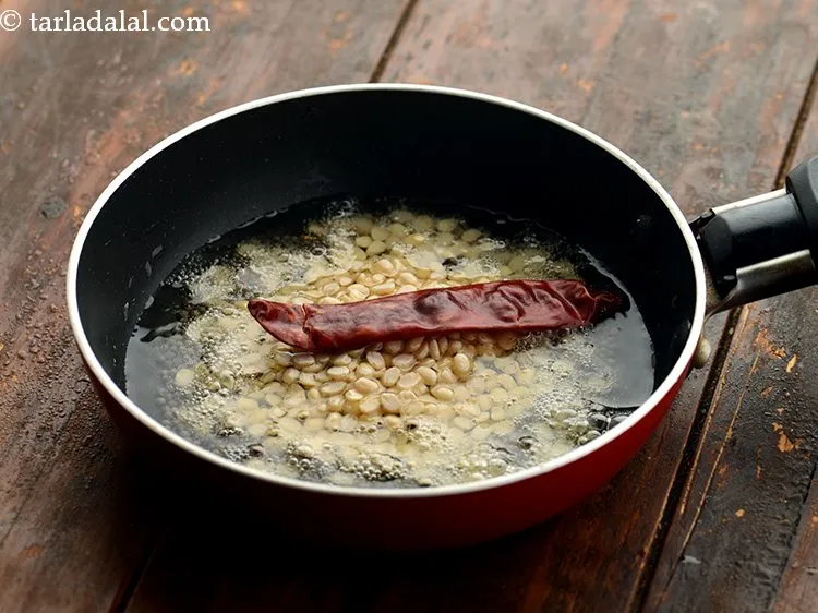 Step 15 – Add red chilli. Remove the stem and break them into pieces before adding.