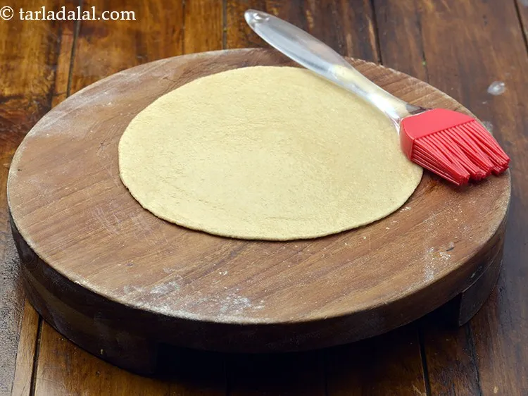 Step 18 – Brush it little with oil. Ensure you spread it evenly over the rolled chapati. This …